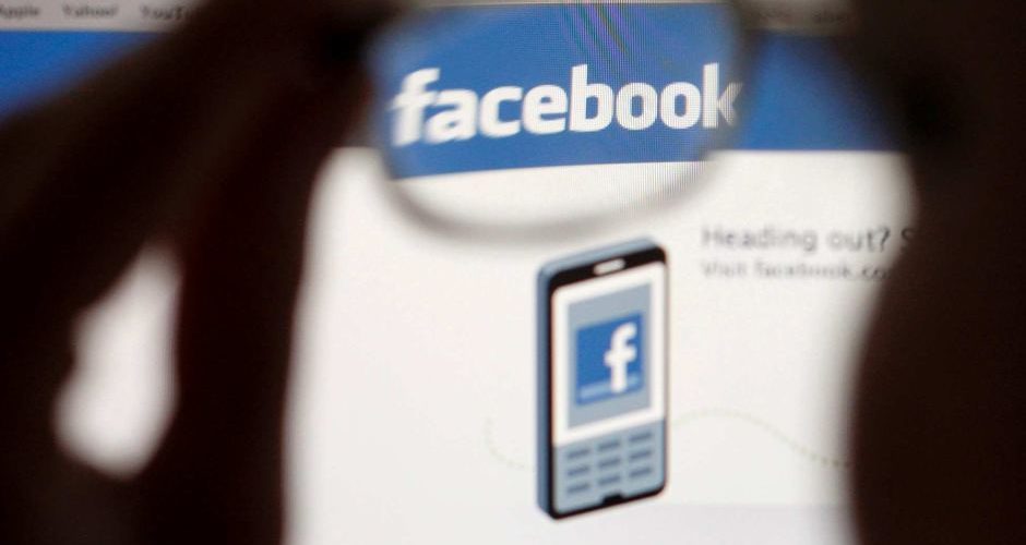 A Facebook logo is seen through glasses